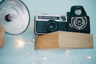 Vintage Instamatic and Ful-Vue Cameras on Wooden Block
