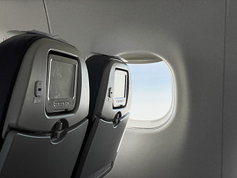 Airplane cabin seats and window view during flight