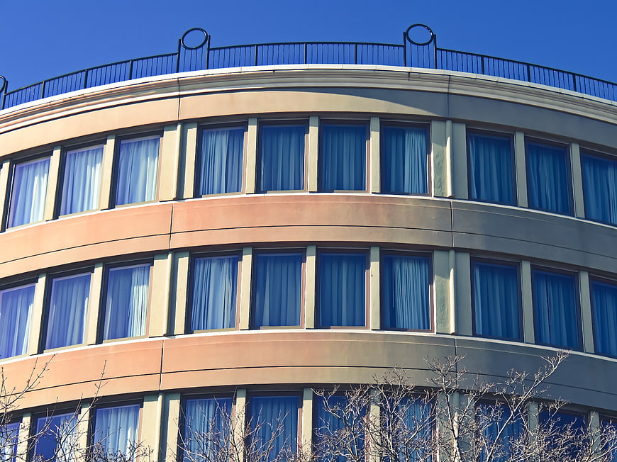 Curved modern office building facade with blue sky