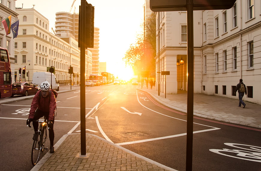 Cyclist on London Street at Golden Hour Sunrise