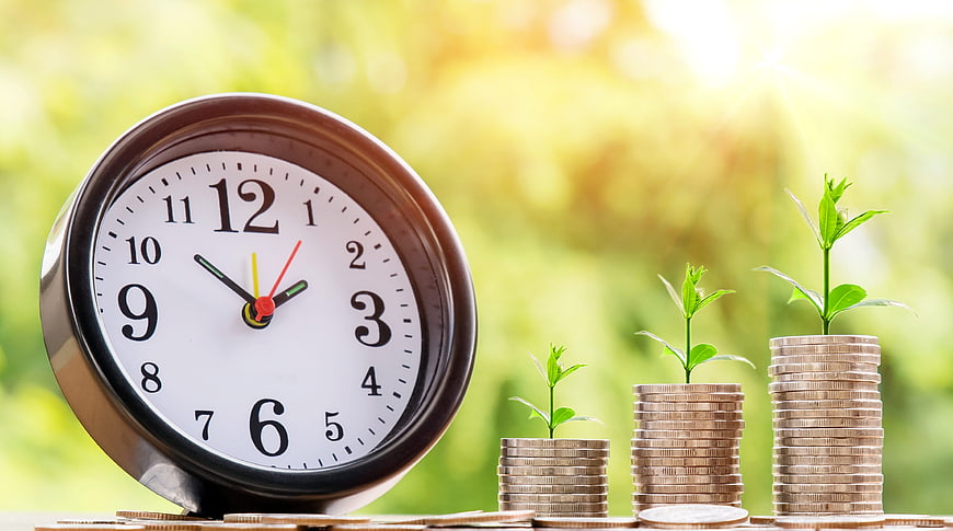 Financial Growth Concept with Clock and Coin Stacks