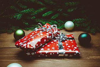 Red Christmas Gifts with Silver Ribbons on Wooden Table
