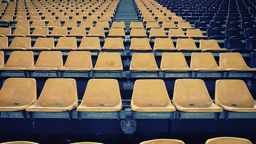 Empty yellow stadium seats in rows