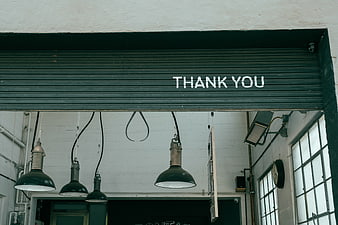 Industrial interior with hanging lamps and thank you sign