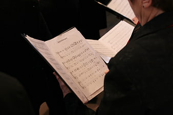 Close-up of choir member holding sheet music