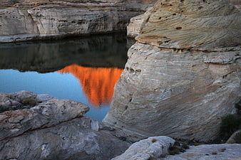 Vibrant Orange Sunset Reflection in Desert Canyon Pool