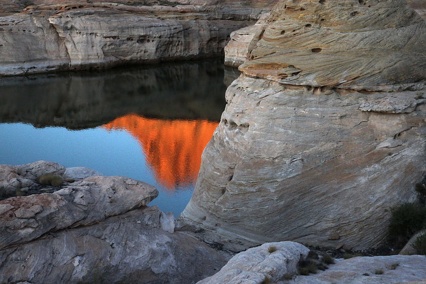 Vibrant Orange Sunset Reflection in Desert Canyon Pool
