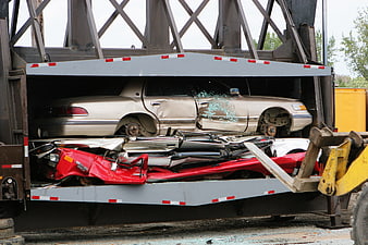 Crushed cars inside a hydraulic car crusher machine
