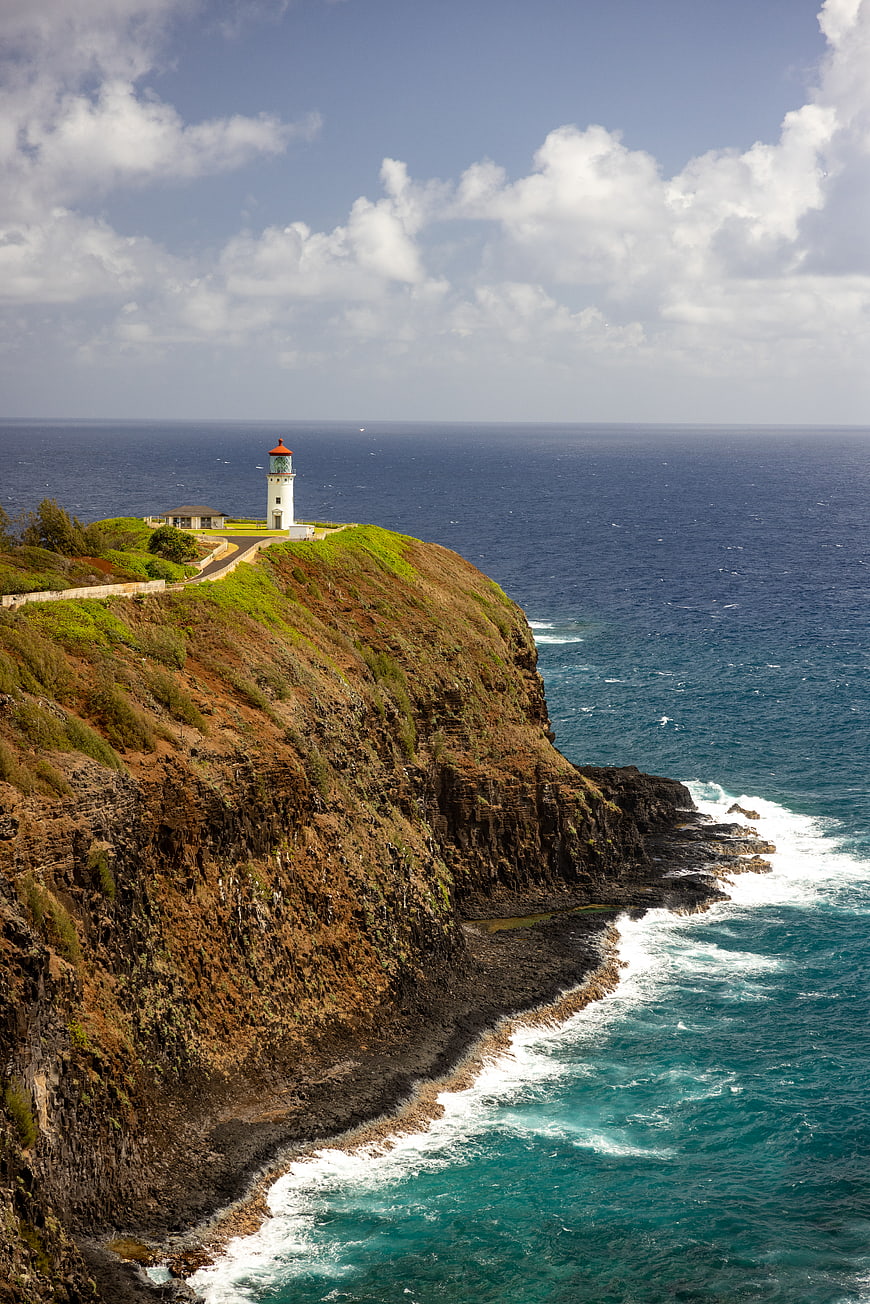 White Lighthouse on Dramatic Coastal Cliff Overlooking Ocean