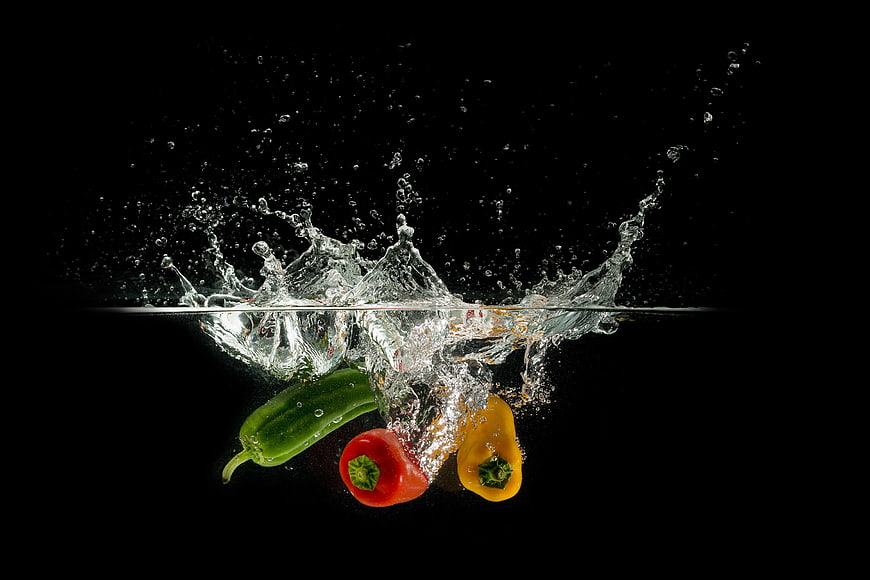 Colorful Bell Peppers Splashing into Water