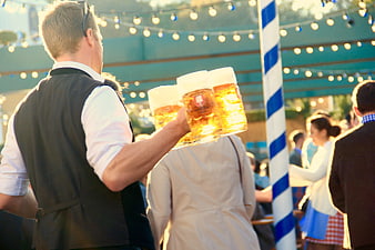 Waiter carrying beer mugs at Oktoberfest Munich