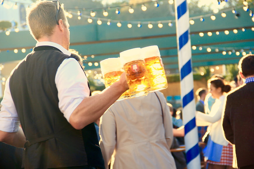Waiter carrying beer mugs at Oktoberfest Munich