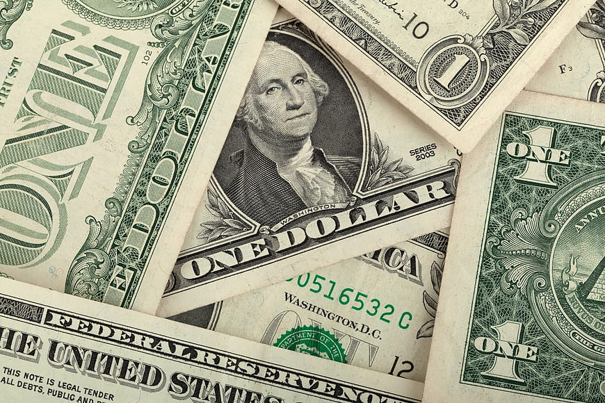 Scattered US One Dollar Bills Close-Up Background