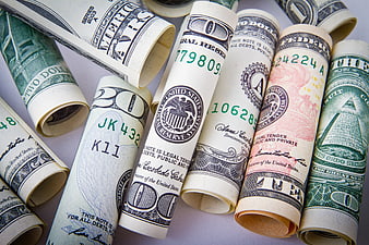 Rolled US Dollar Bills on White Background