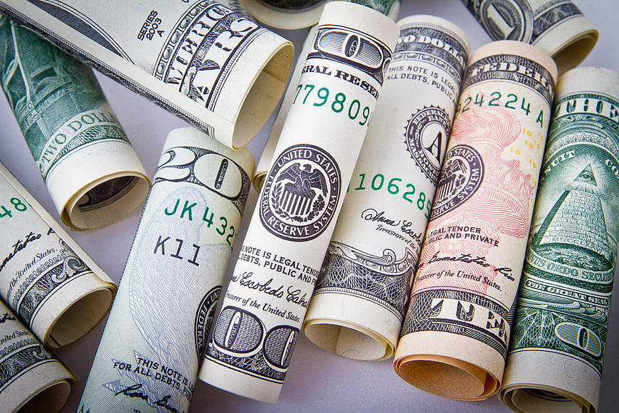 Rolled US Dollar Bills on White Background