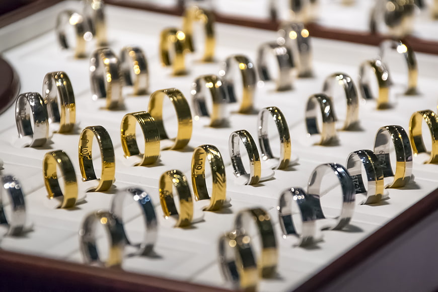 Gold and silver wedding bands in jewelry display tray