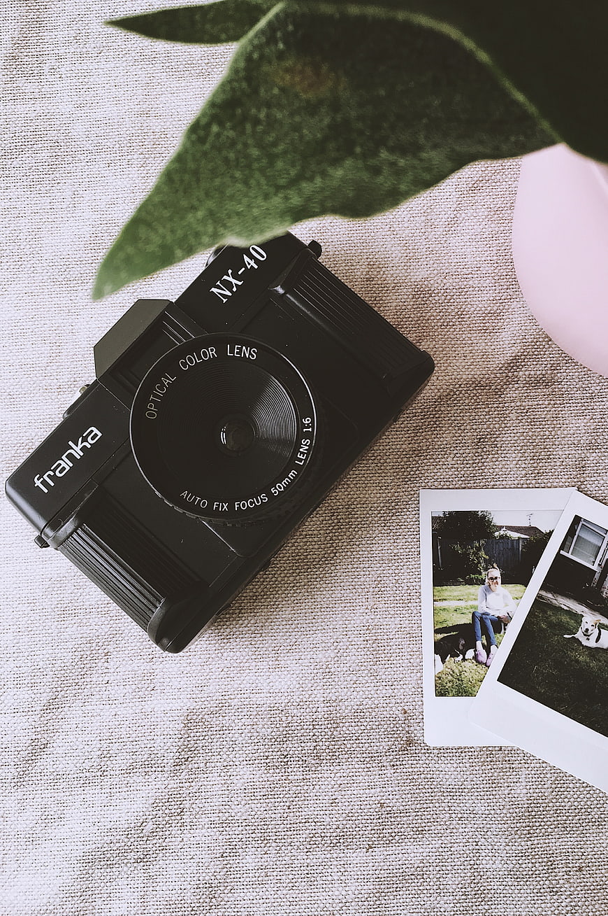 Vintage Black Franka Camera with Photos and Plant