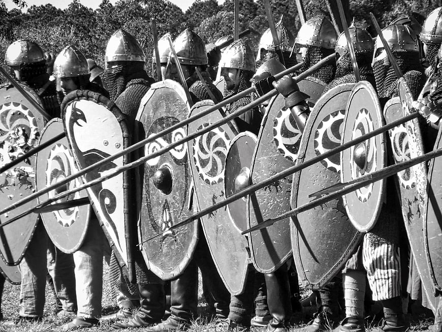 Black and white medieval warriors in shield wall formation