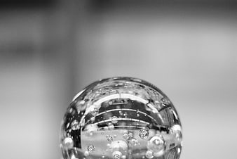 Close-up of a glass sphere with bubbles in black and white