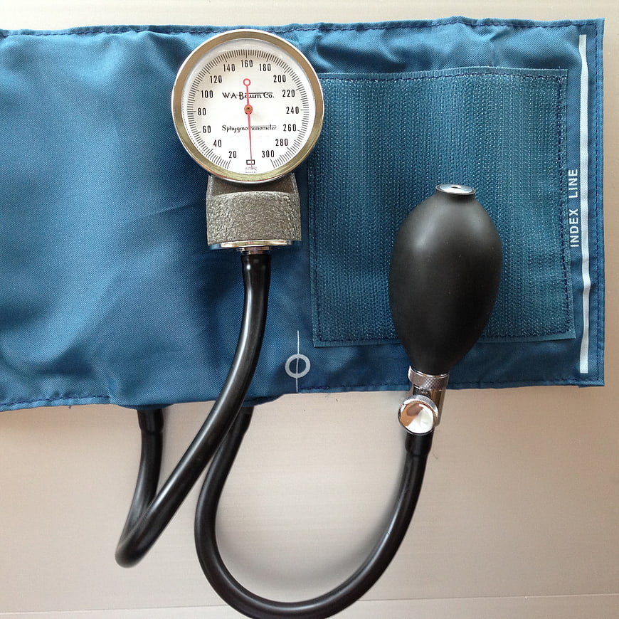 Blue manual sphygmomanometer blood pressure cuff on white background