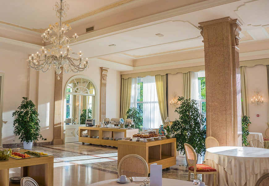 Luxury hotel breakfast room with chandelier and buffet