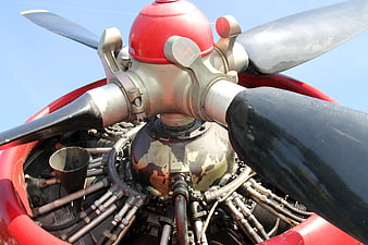 Close-up of vintage red airplane radial engine and propeller