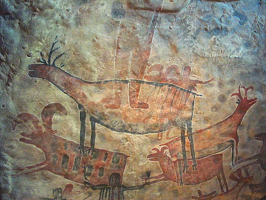 Ancient prehistoric cave painting of deer and human figures