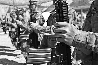 Black and white close-up of soldier holding rifle in formation