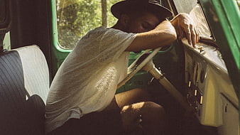 Tired man sleeping in vintage car interior