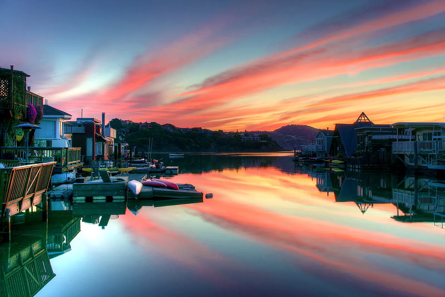 Vibrant Sunset Over Waterfront Houses and Docks