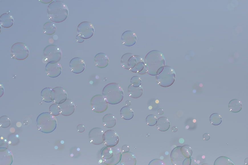 Floating Soap Bubbles with Iridescent Highlights on Blue Background