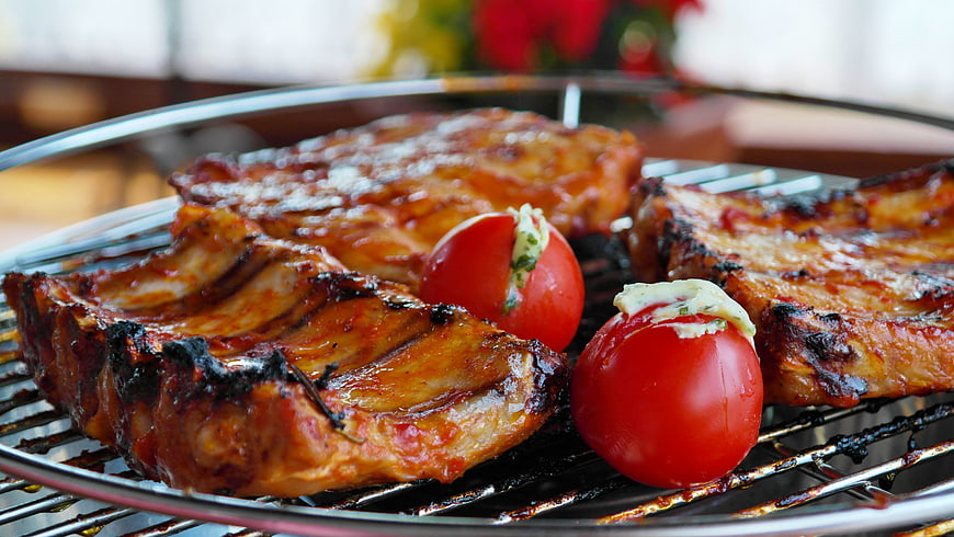 Grilled Pork Ribs and Tomatoes on BBQ Grill