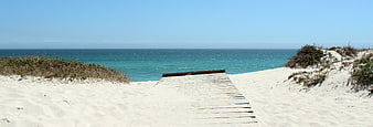 Wooden Boardwalk Path Leading to Turquoise Ocean Beach