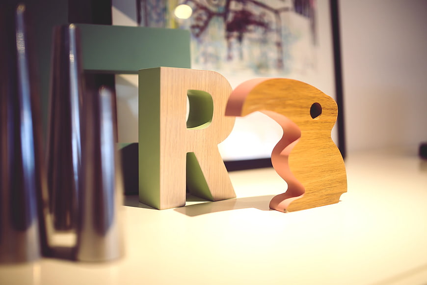 Wooden Letter R and Decorative Sculpture on Desk