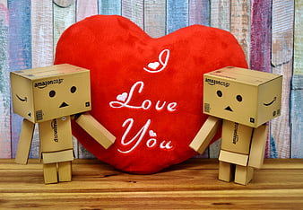 Two Danbo cardboard figures with red love heart pillow