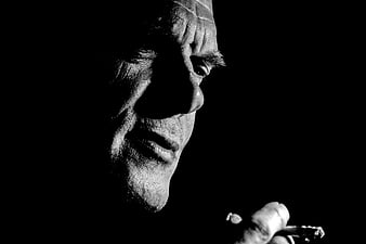 Dramatic Black and White Close-Up Portrait of a Pensive Man Smoking