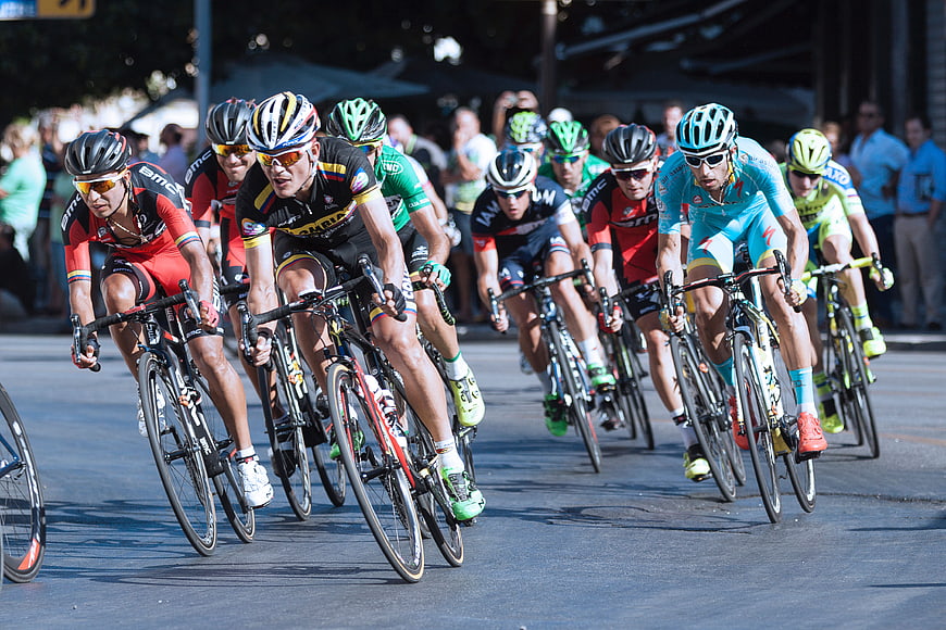 Professional Cyclists Racing on Road in Competition