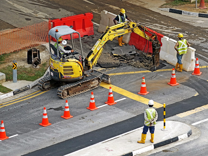 High angle view of road construction with excavator and workers