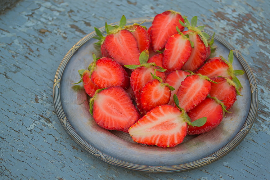 Sliced Strawberries on Rustic Blue Wooden Table