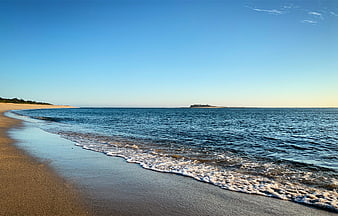 Serene Beach Landscape with Gentle Waves and Distant Island