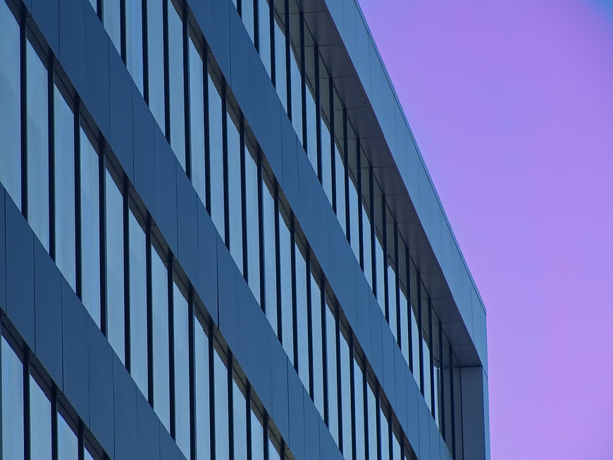 Modern Office Building Facade Against Purple Sky
