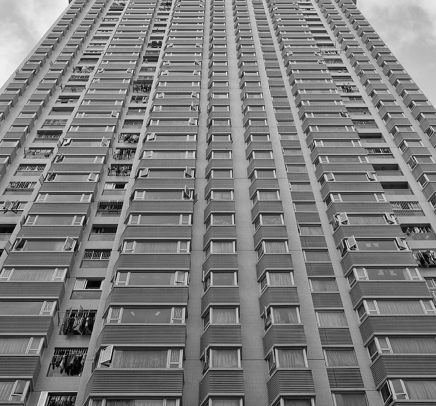 Black and white low angle view of high-rise apartment building facade