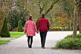 Couple Walking Hand in Hand in Park