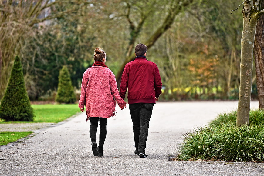 Couple Walking Hand in Hand in Park