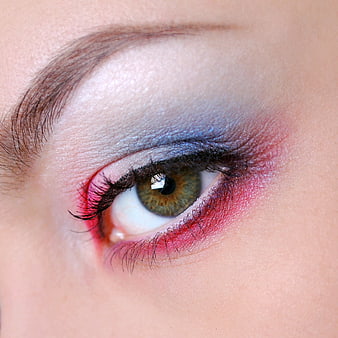 Close-up of eye with blue and pink glitter makeup