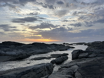 Dramatic Sunset Over Rocky Coastal Tide Pools