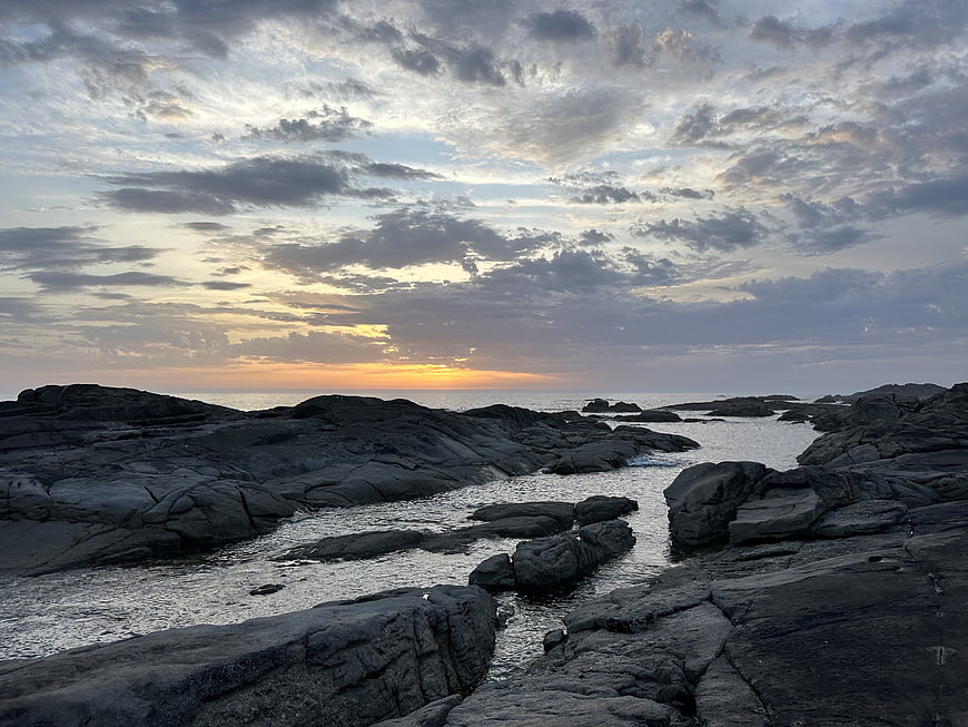 Dramatic Sunset Over Rocky Coastal Tide Pools