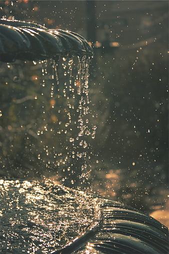Close-up of water droplets falling from a fountain spout