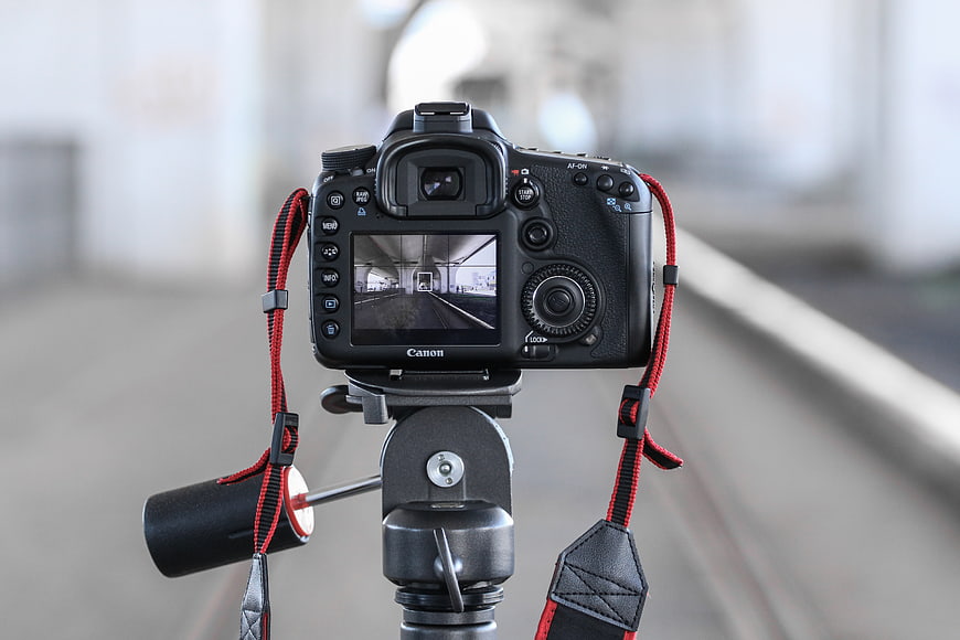 Canon DSLR Camera on Tripod with Red Strap