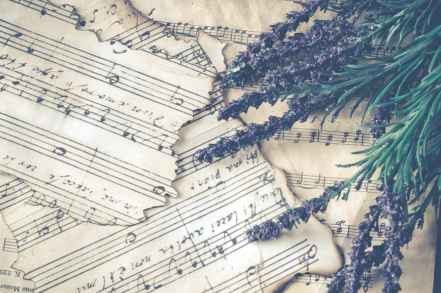 Vintage sheet music with dried lavender and rosemary